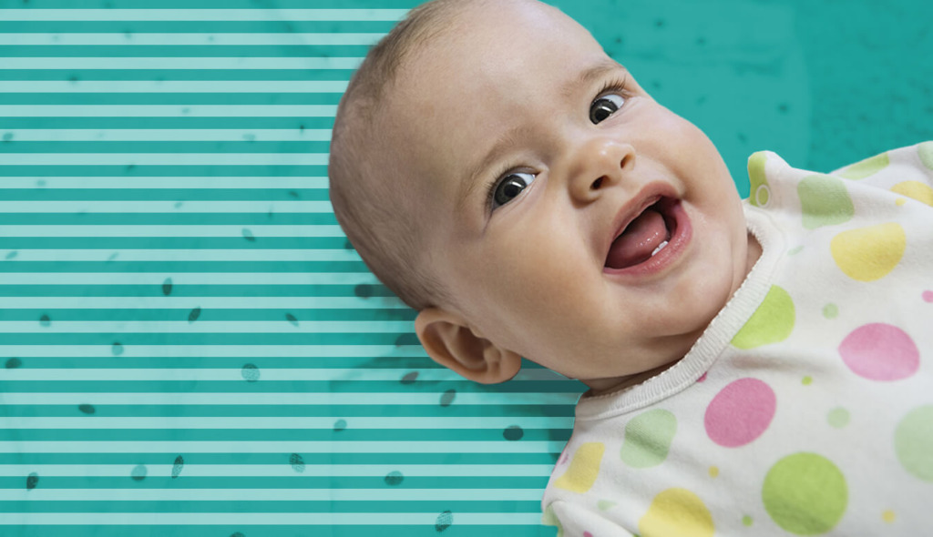 Baby laying down and smiling